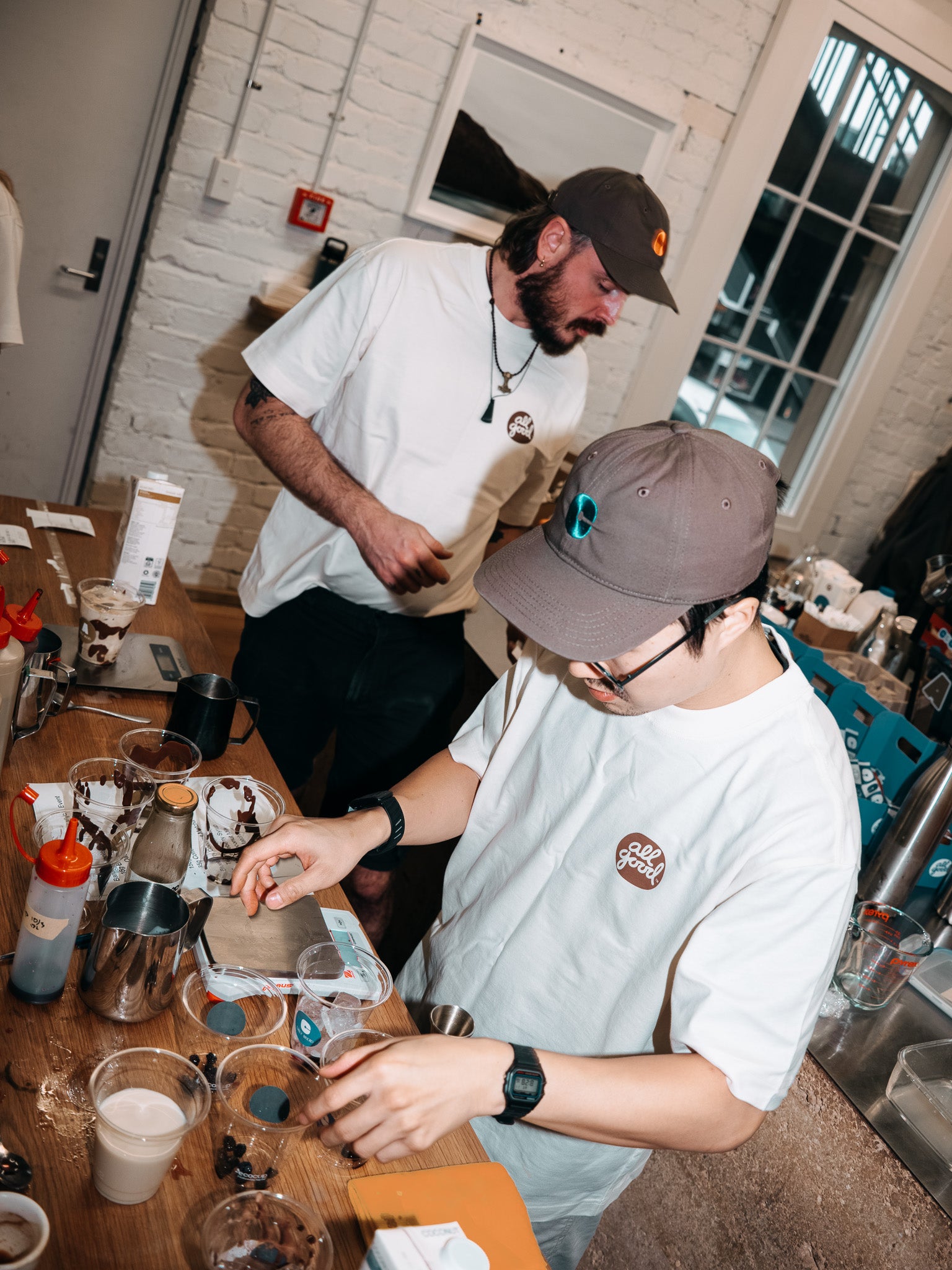 Baristas working together behind the coffee bar