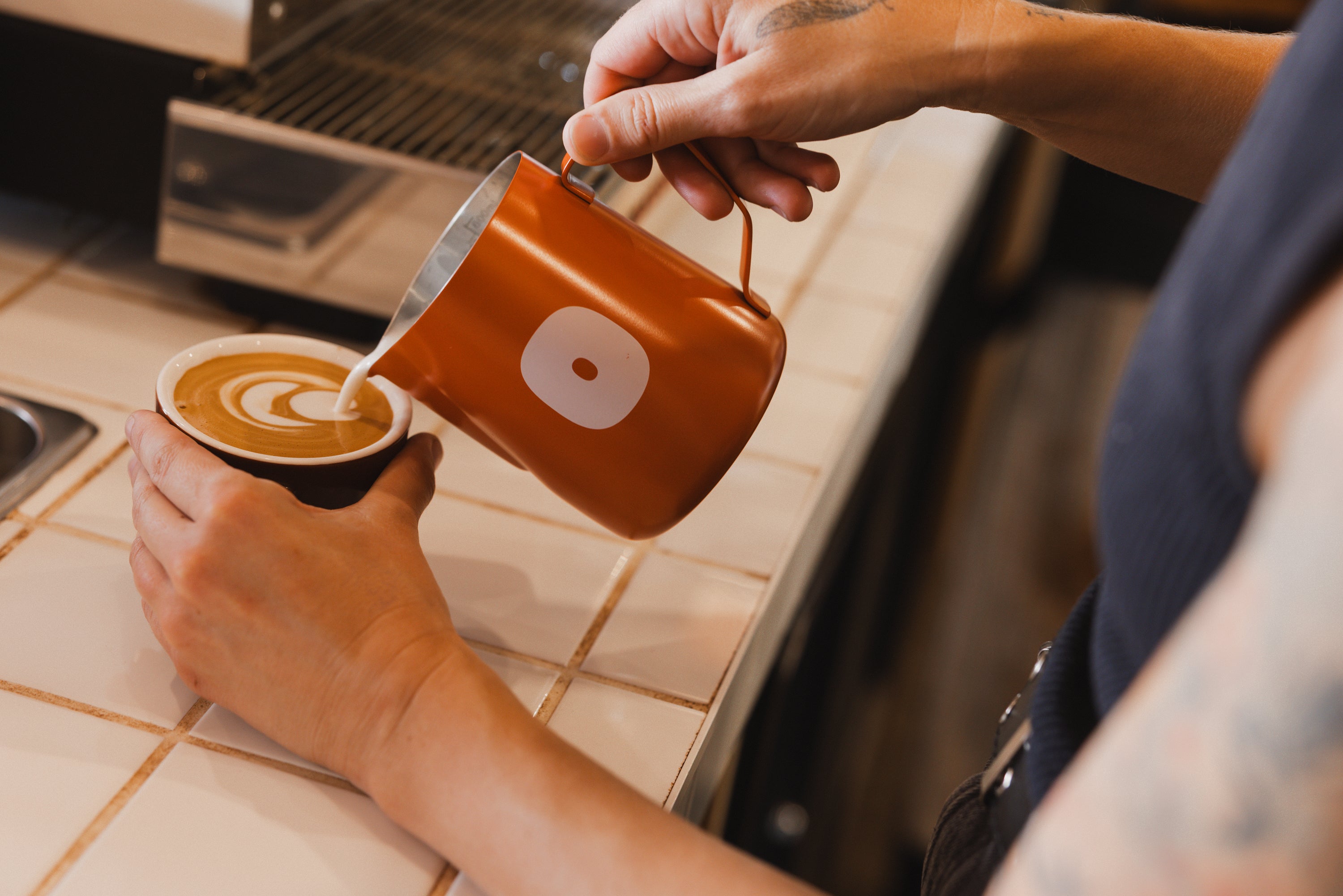 Pouring All Good milk into a coffee