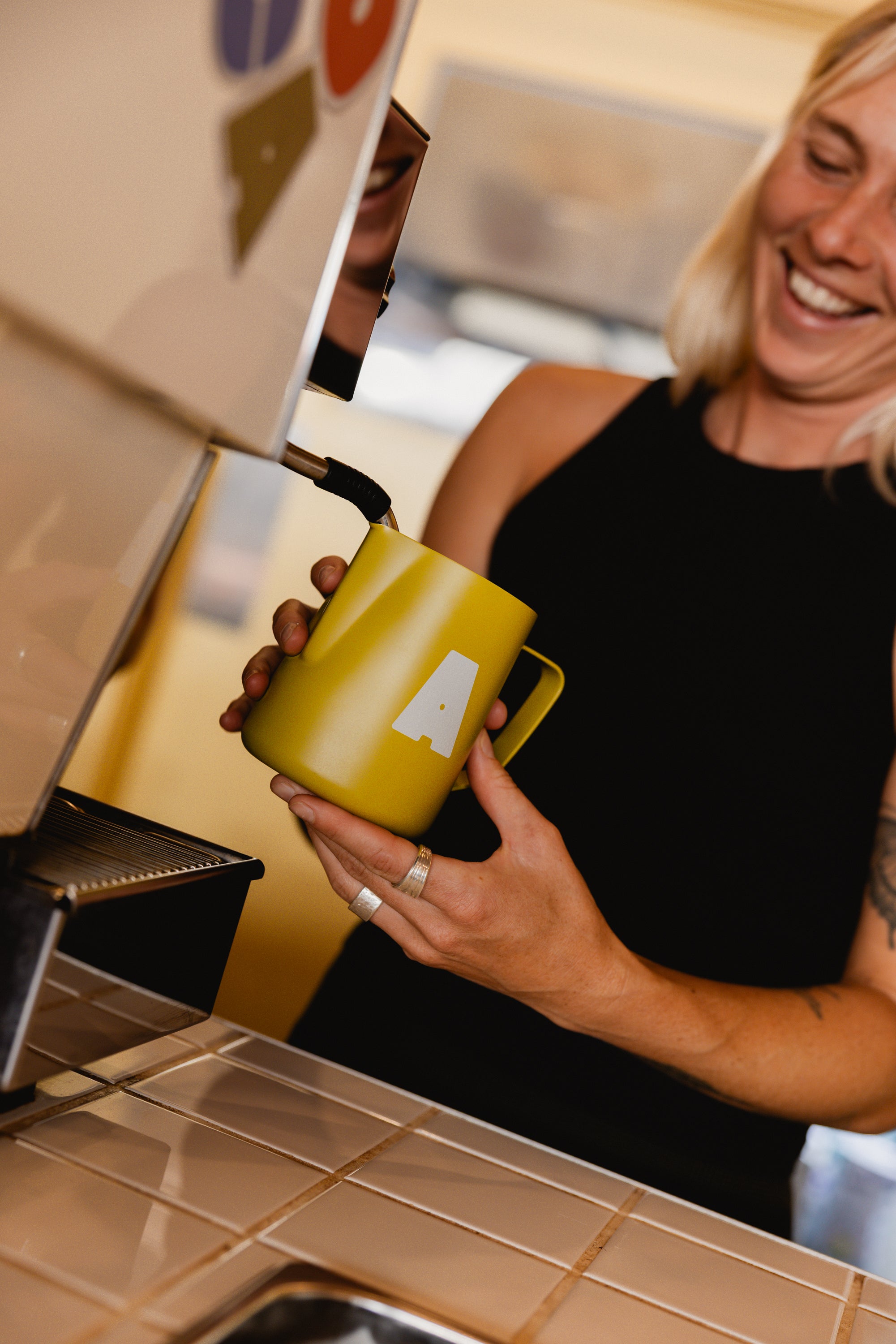 Barista holding an All Good milk jug
